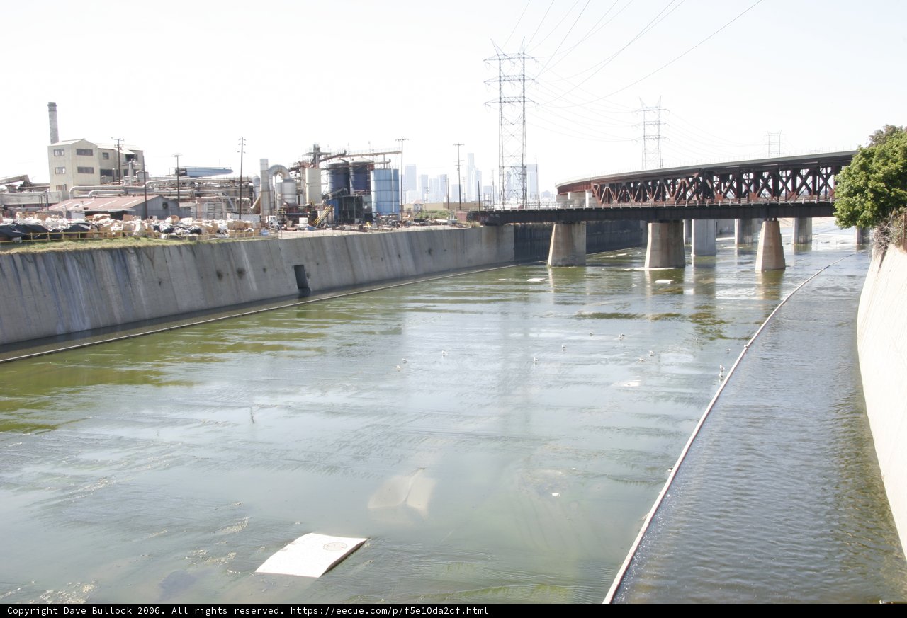 Serene River Flowing under a Bridge