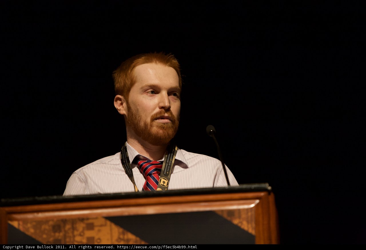 Red-Bearded Speaker at Podium