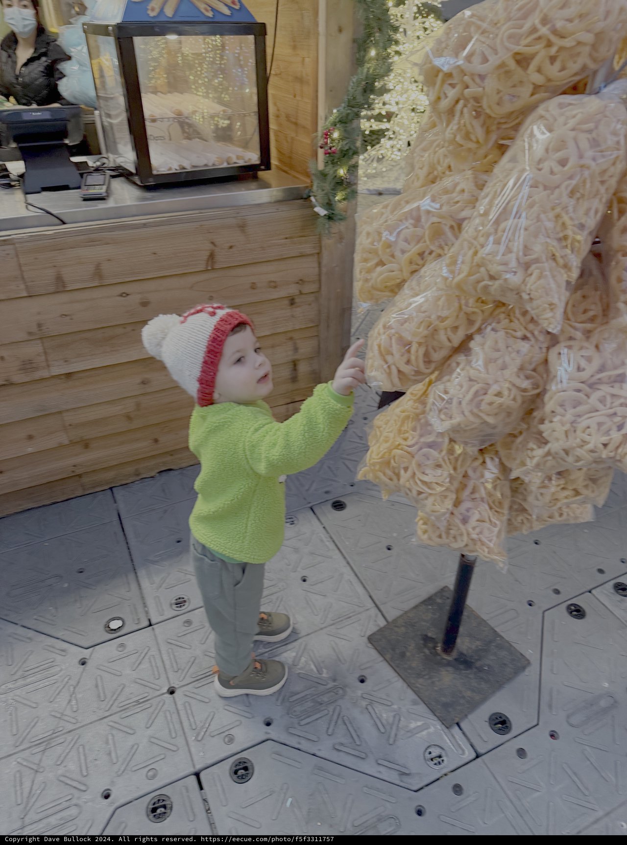 Young Child Explores Wood Shaving Sculpture Display
