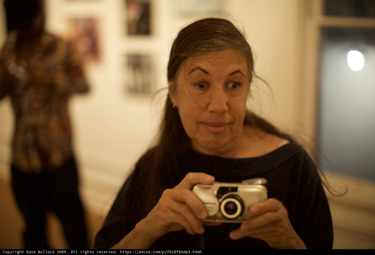 Candid Shot of a Female Photographer Taking Pictures with a Camera