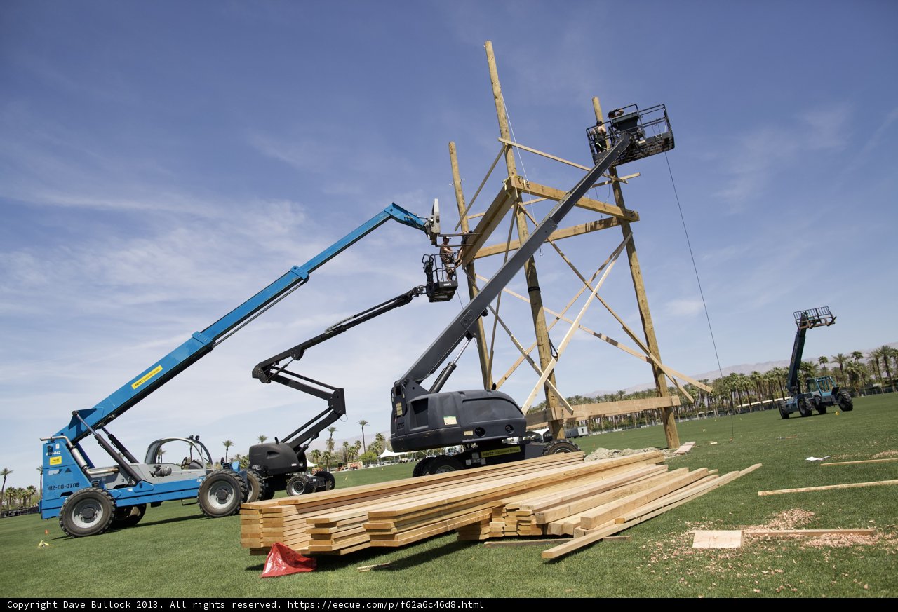 Wooden Construction Crane Lifts Lumber