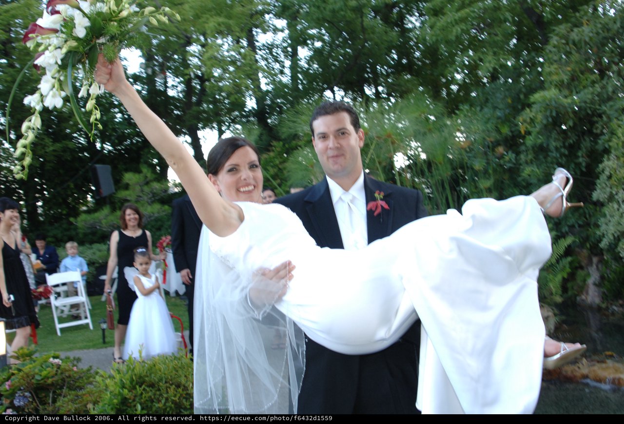 Groom Carries Bride in Joyful Wedding Celebration