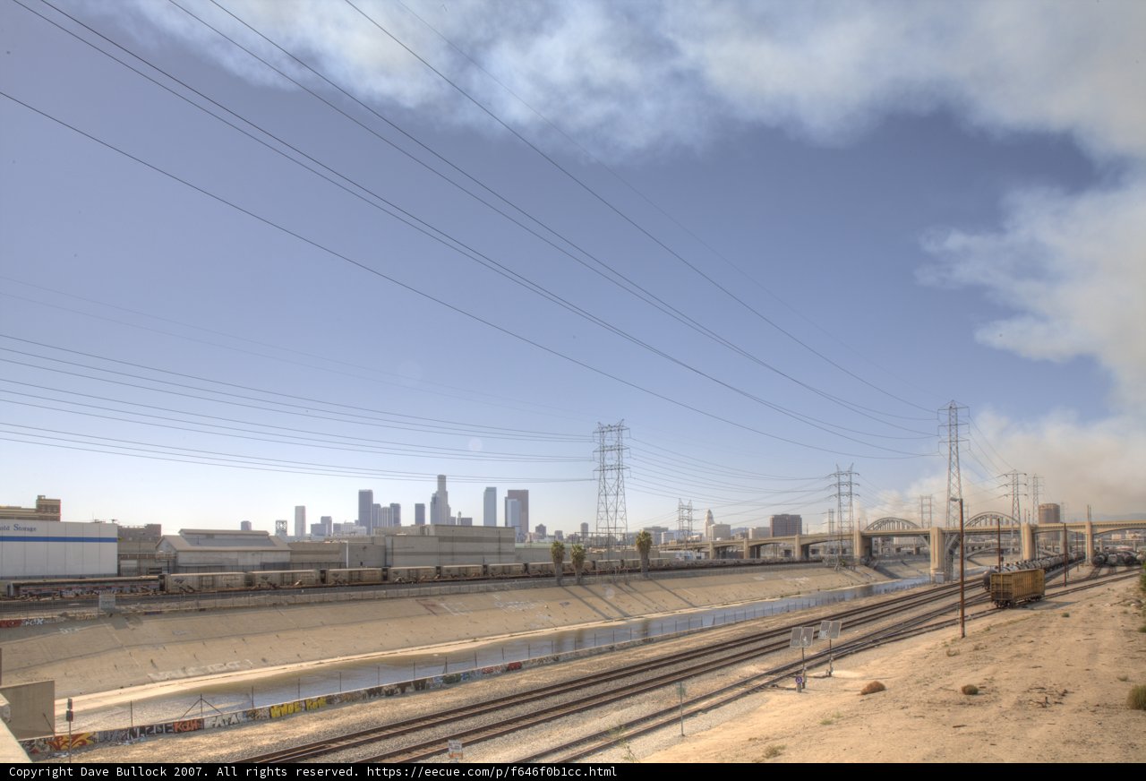 Smoke-Belching Train Passing by a City