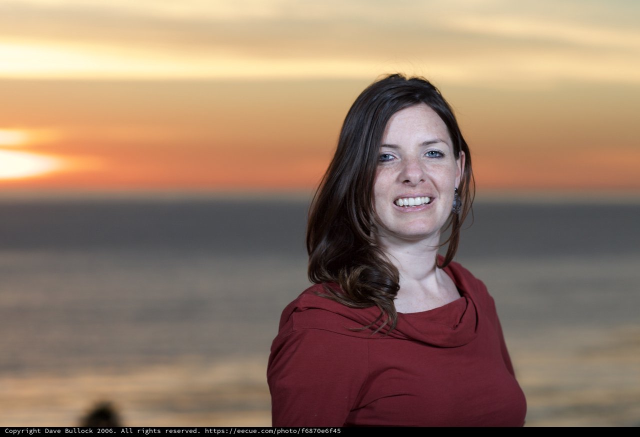 Smiling Woman at Golden Hour Seaside Sunset