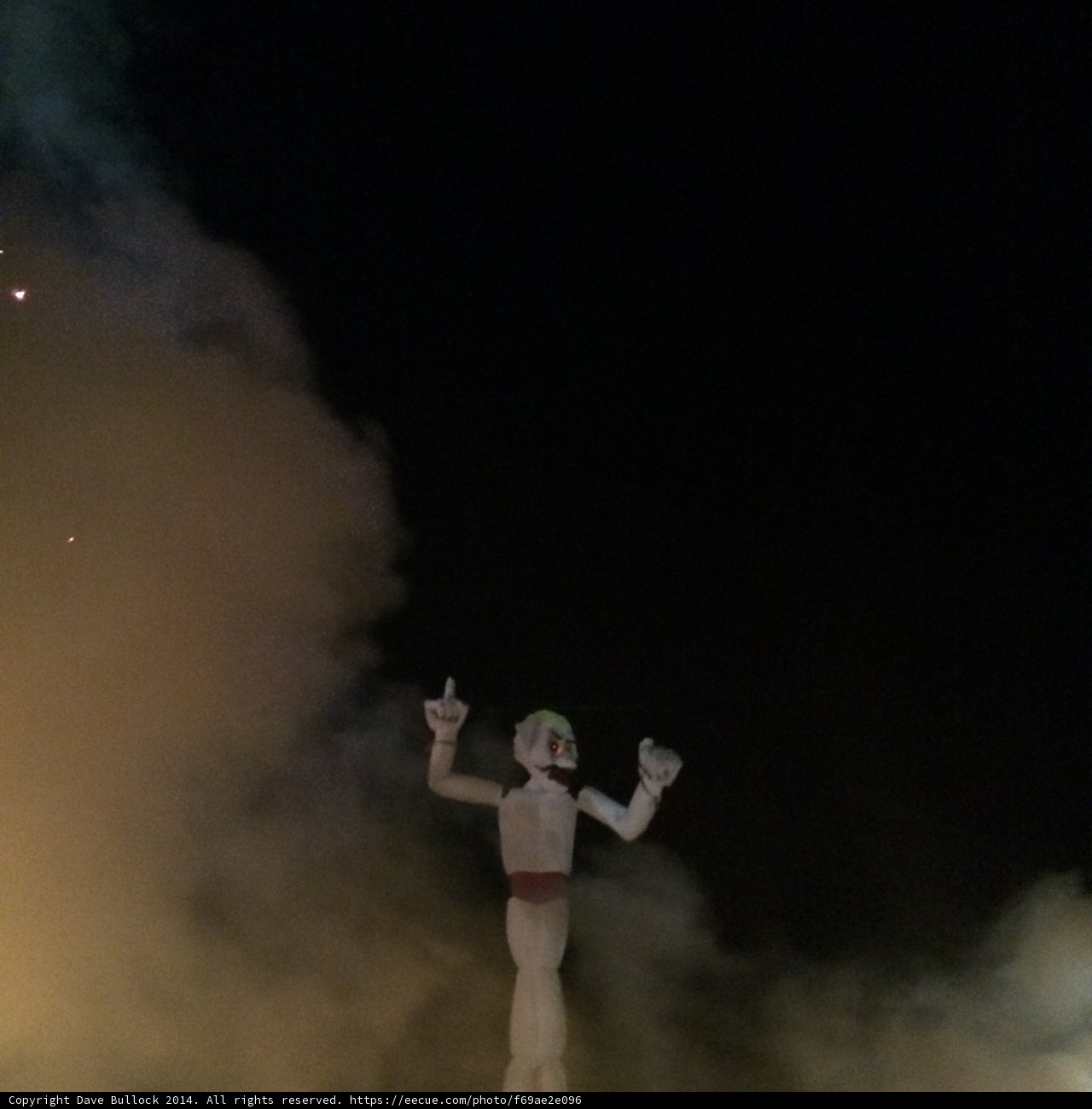 Man in White Suit Dancing in Front of a Fire