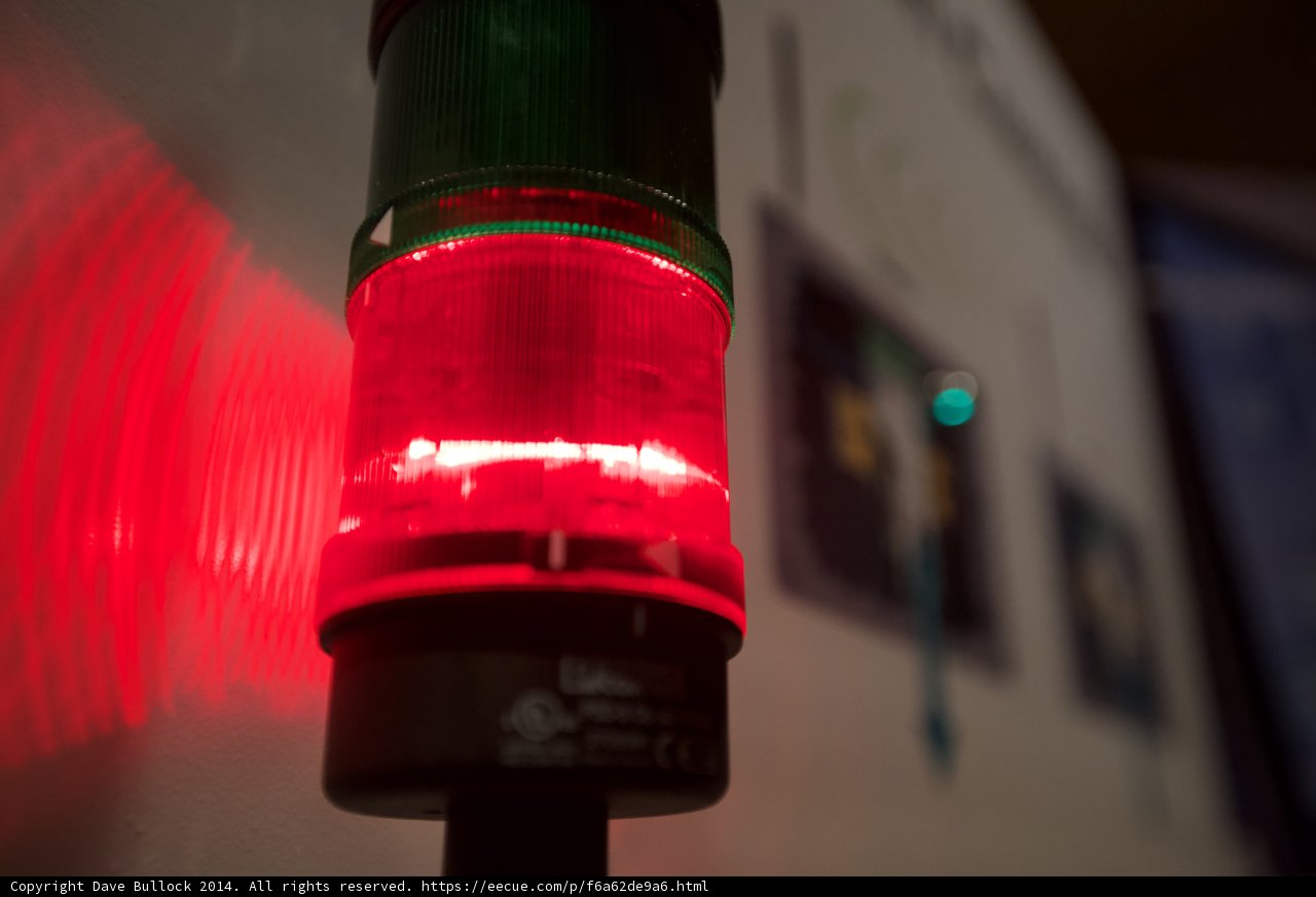 Red Traffic Light Illuminates Wall