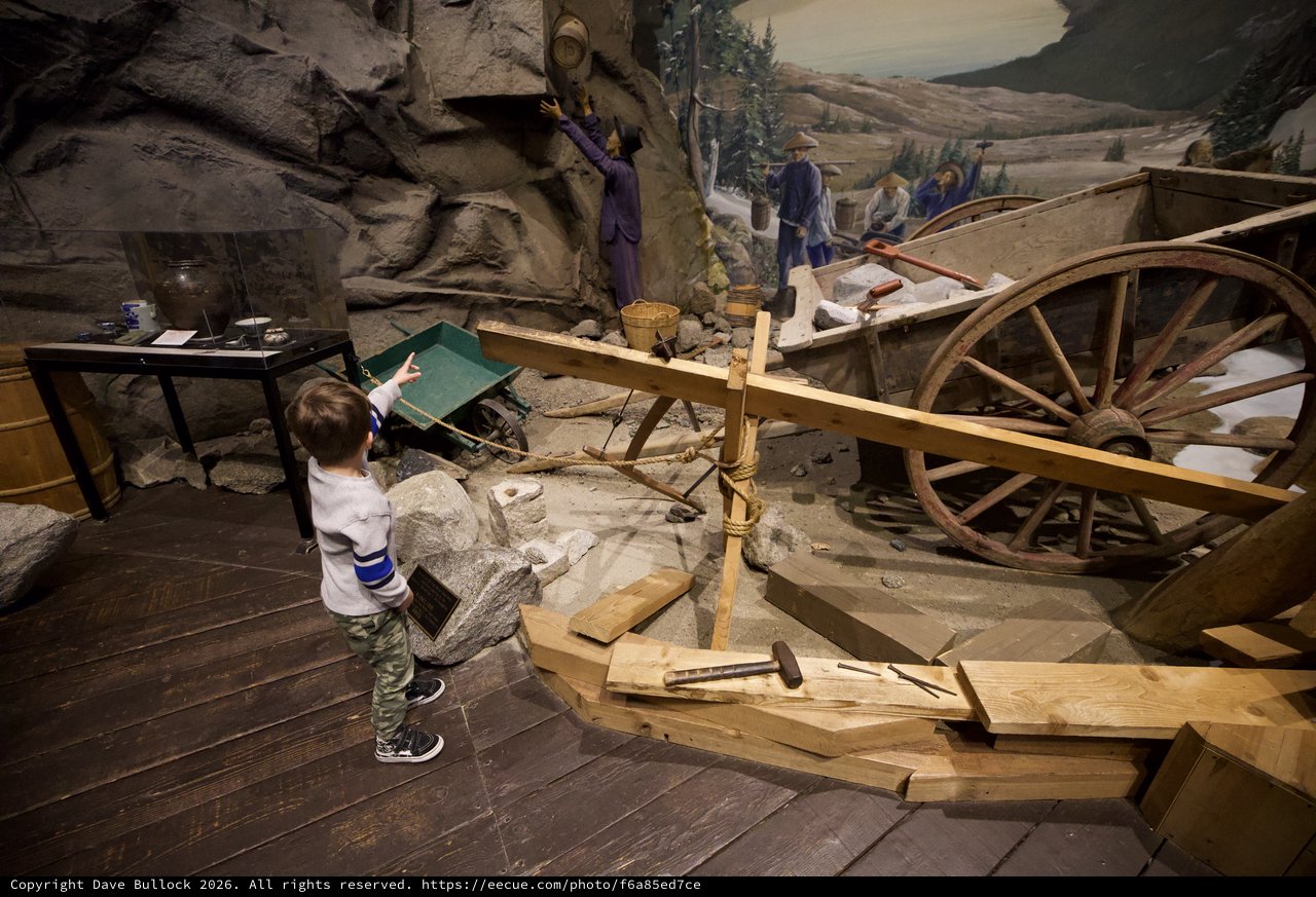 Young Child Exploring Interactive Gold Rush Mining Museum Exhibit