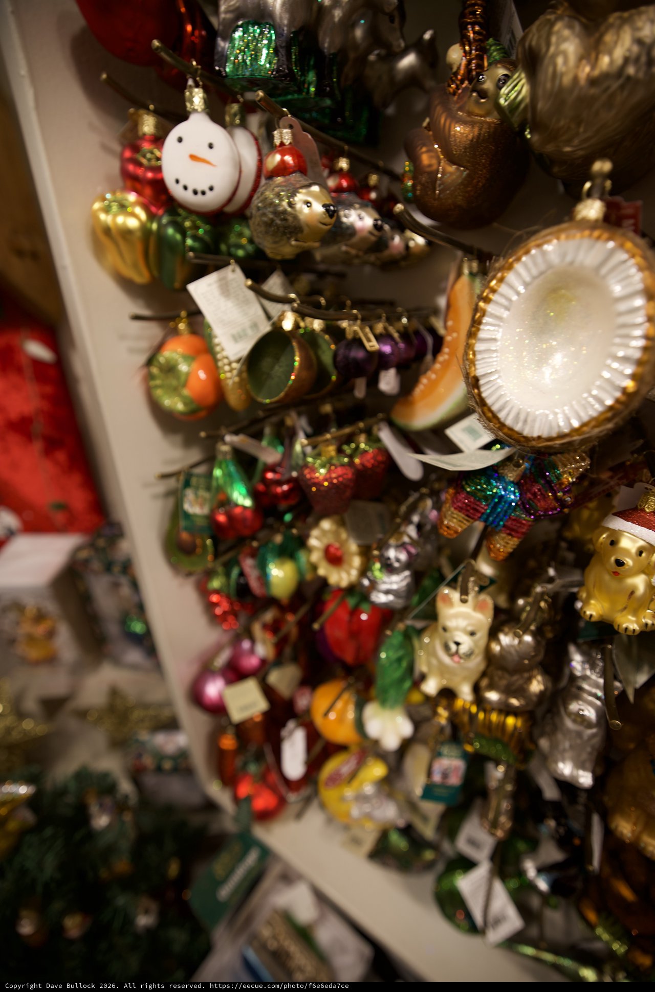 Colorful Christmas Ornament Collection Display on White Shelves