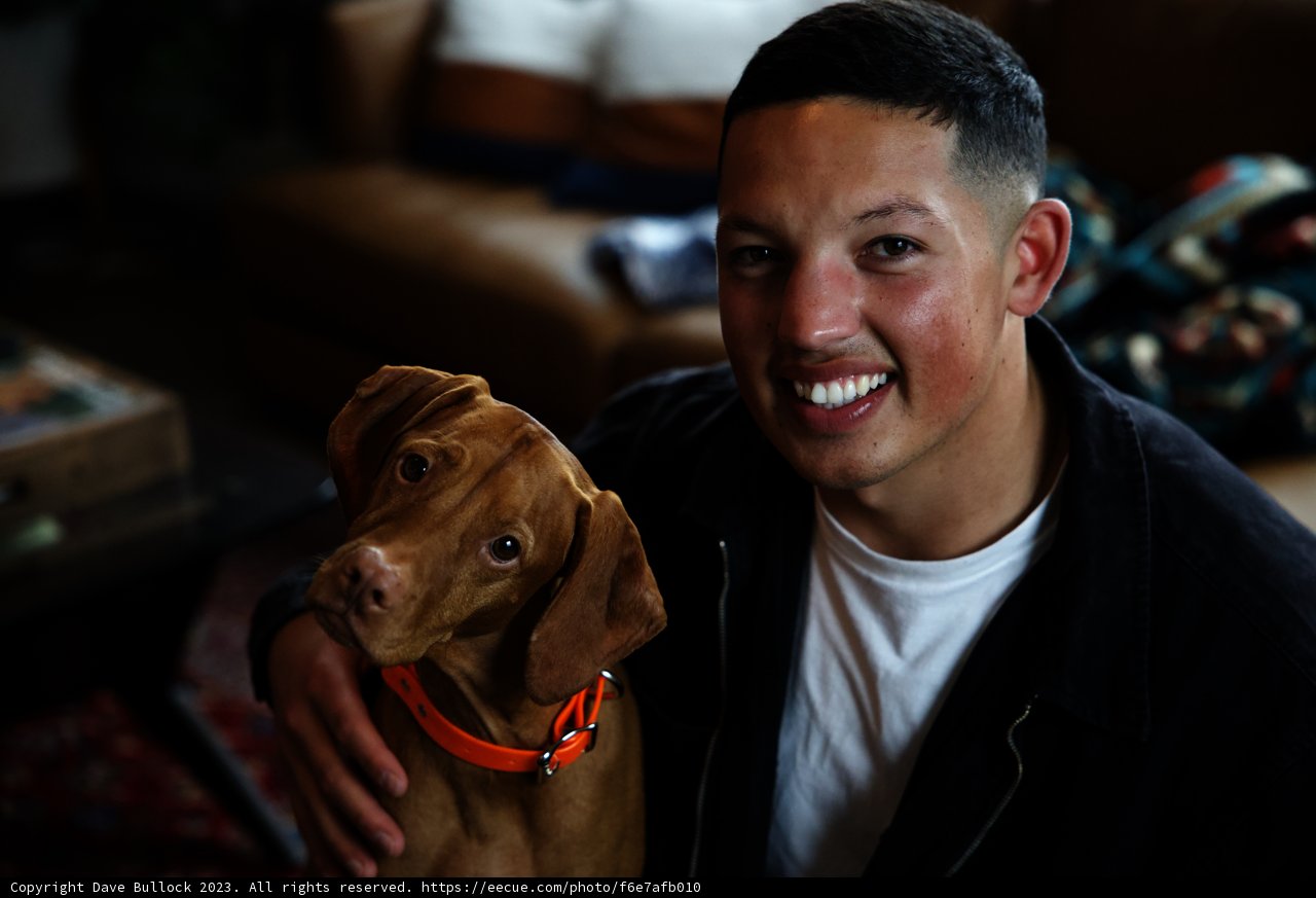 Man and dog share a happy moment on the couch
