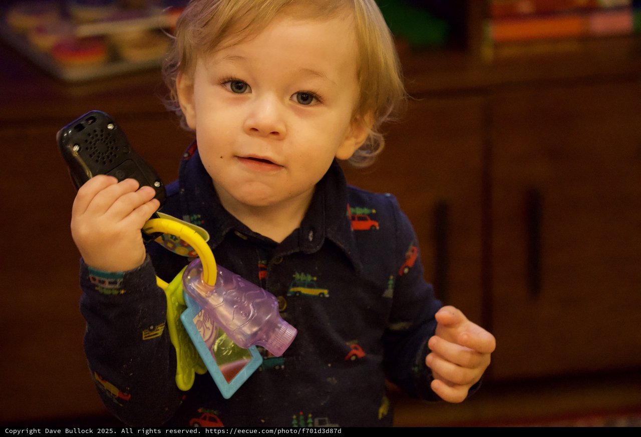 Toddler Playing with Phone and Keys at Christmas Time
