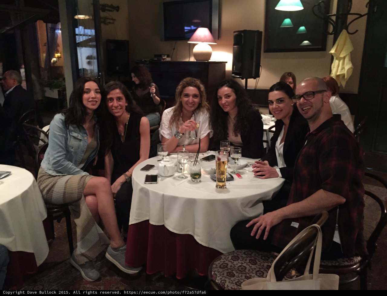 Friends Gathered Around Restaurant Table for Evening Dinner