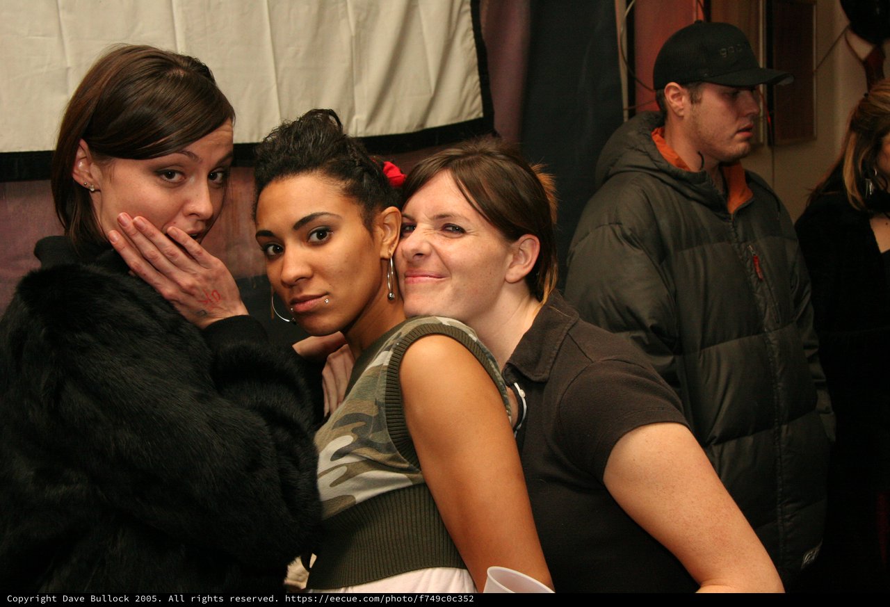 Three Friends Posing Together at Indoor Event