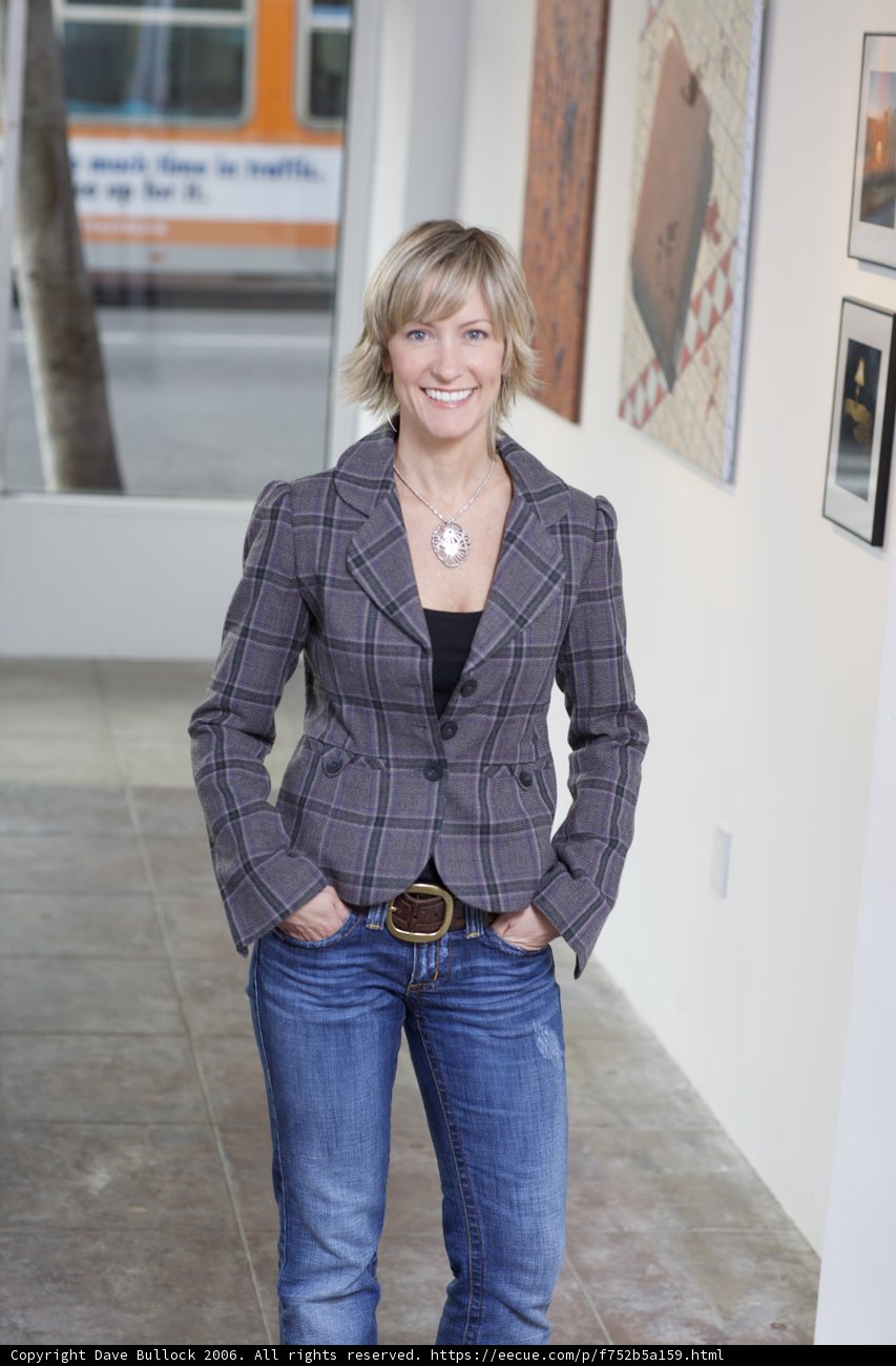 Woman in Plaid Jacket Admiring Art in Gallery