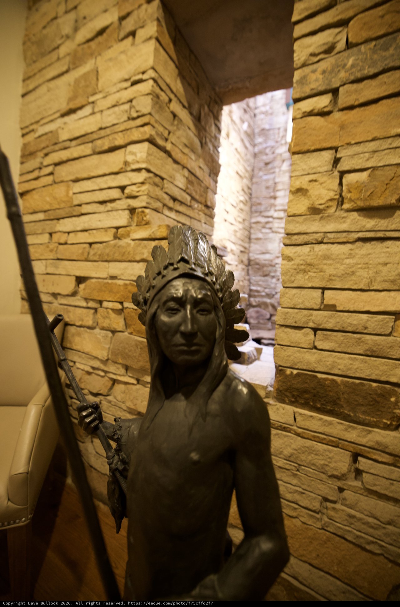 Bronze Statue in Rustic Stone Corridor