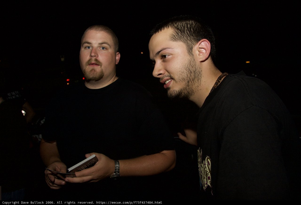 Two Men Standing Next to Each Other