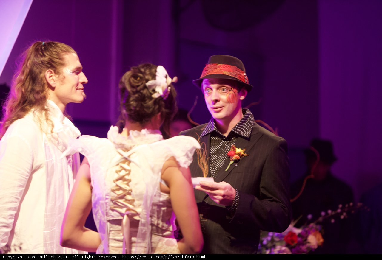 Hat-Wearing Man Chats with Two Women at 2011 Wickstrom Wedding