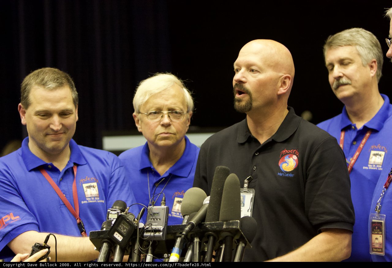 Blue-Shirted Men in Post-Interview Conference