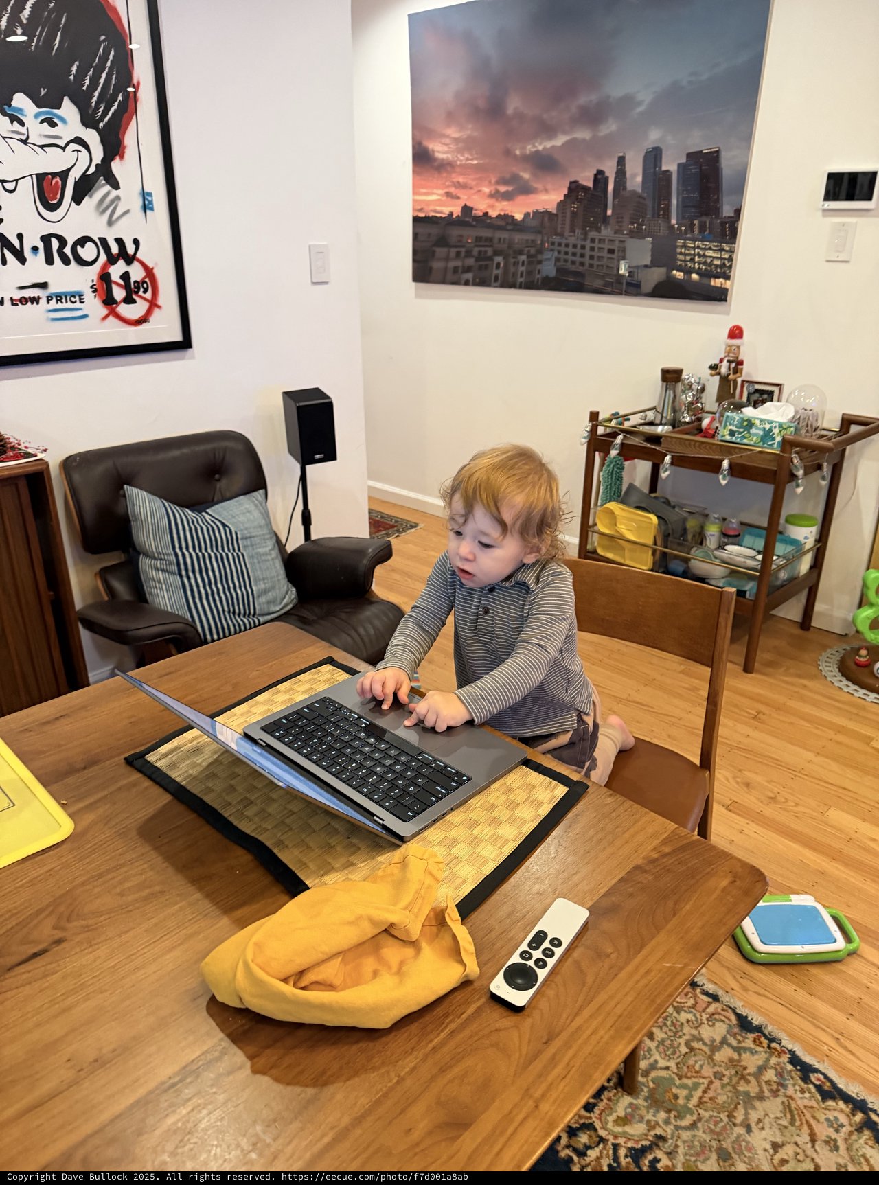 Toddler Working at Laptop in Modern Urban Apartment