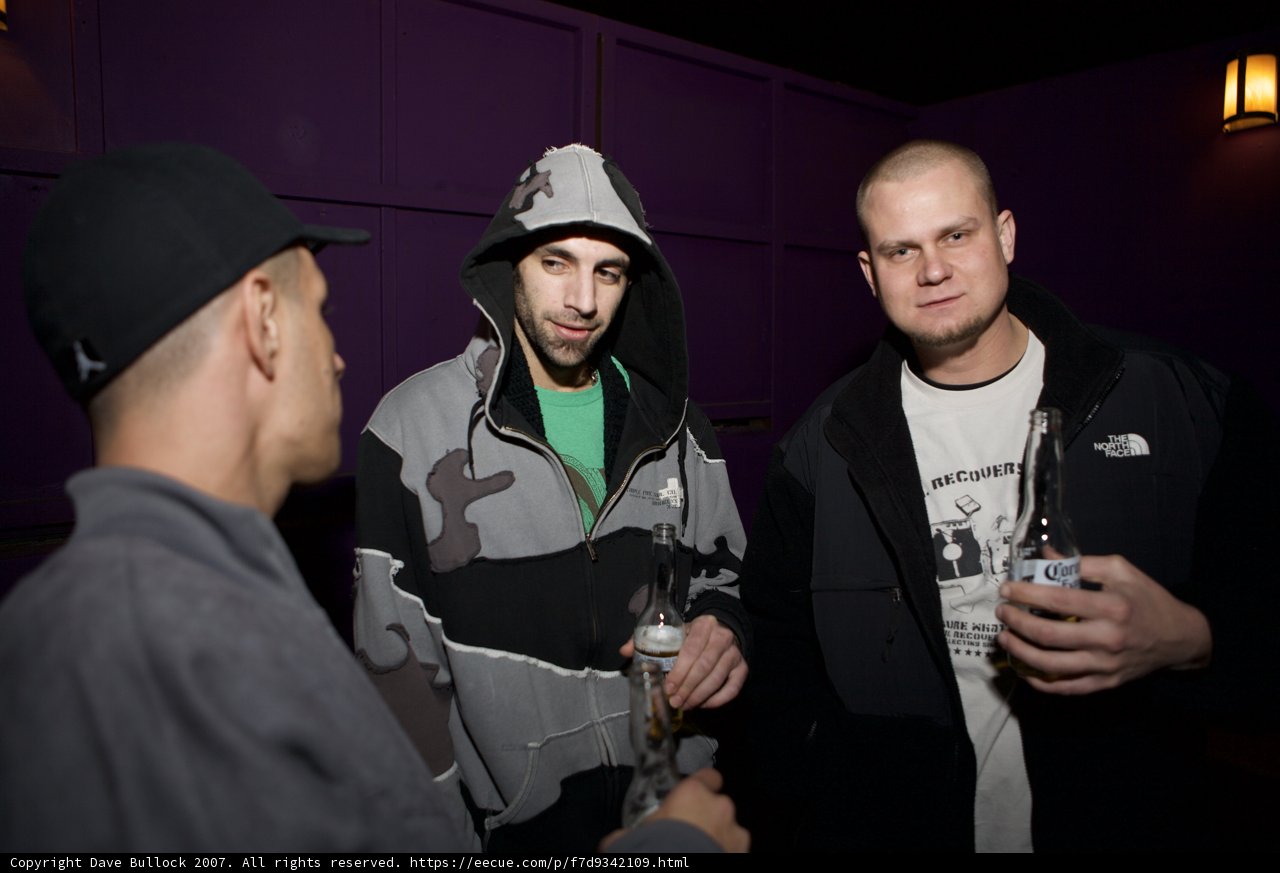 Three Men Cheers-ing at a Party