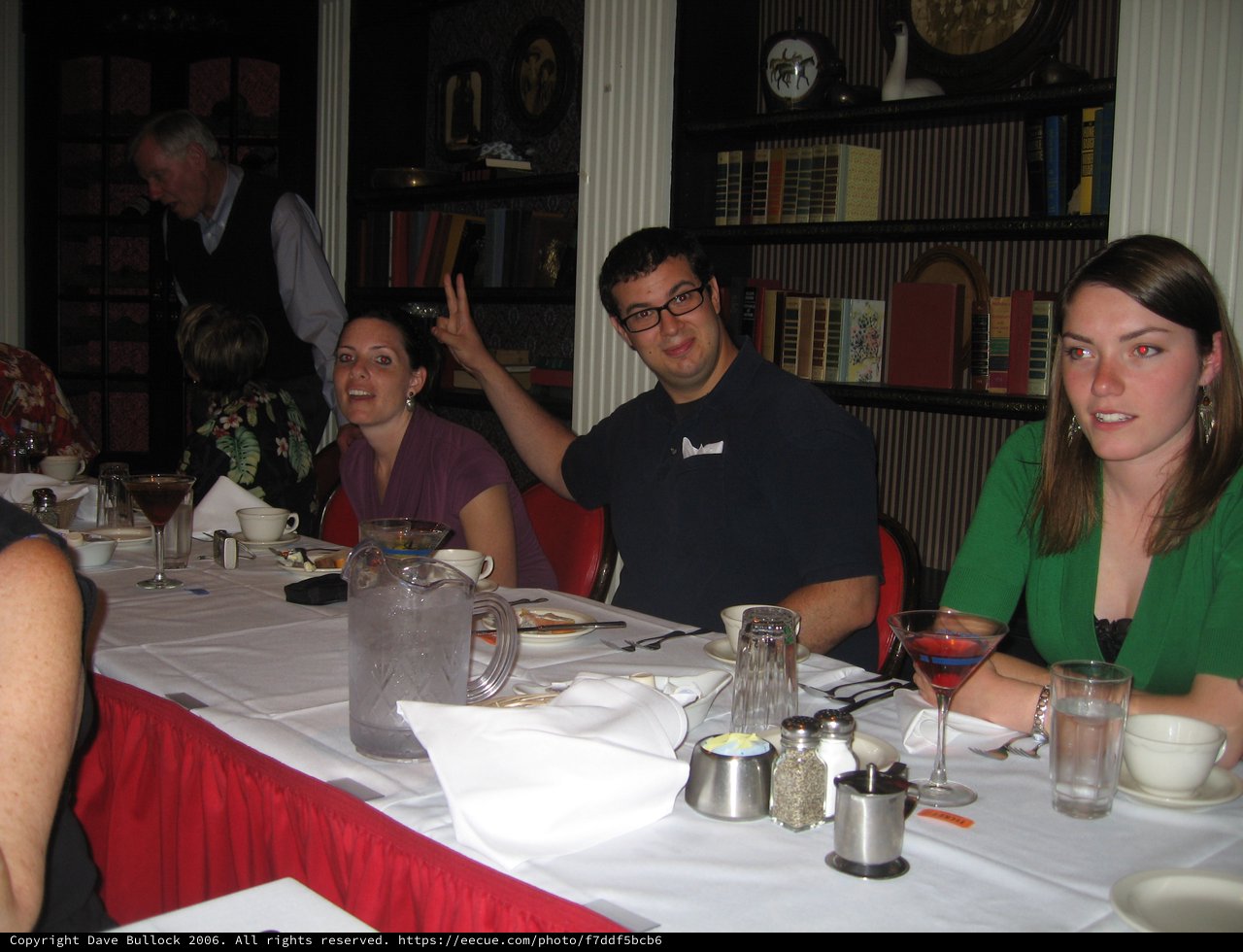 Friends Laughing Together at Restaurant Dinner Table