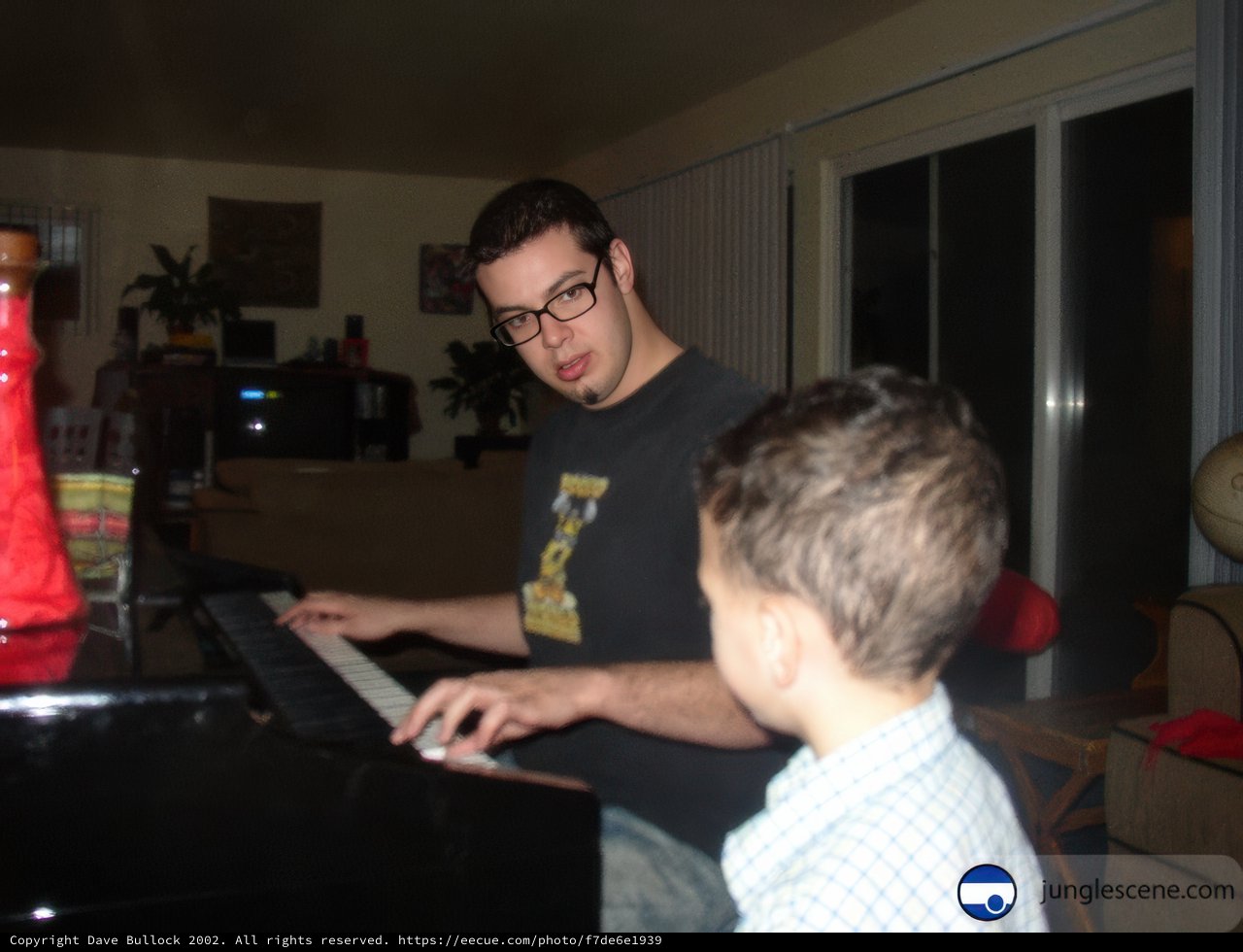 A Joyful Duet: Father and Son Play the Piano Together