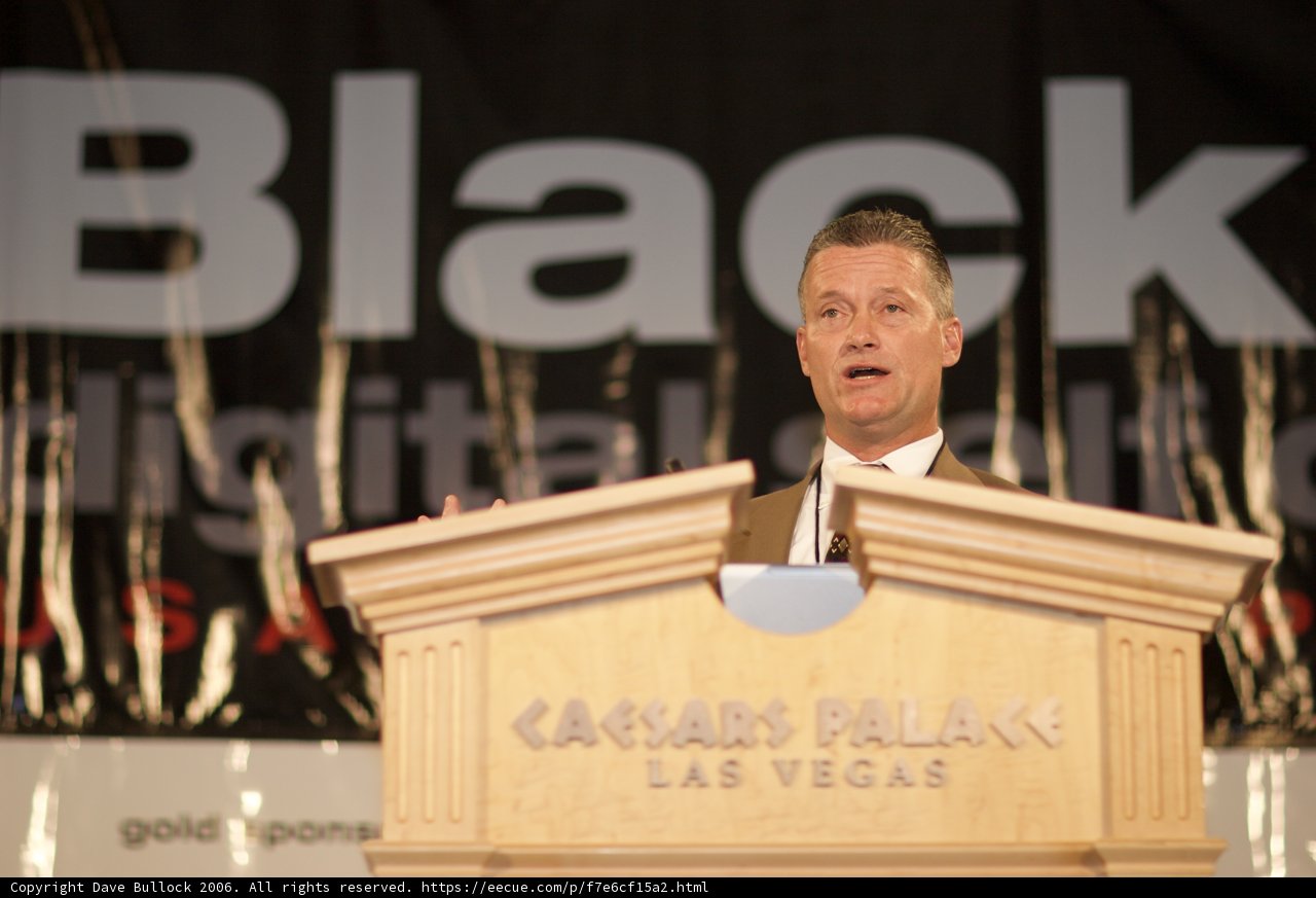 Man addressing a crowd from a podium
