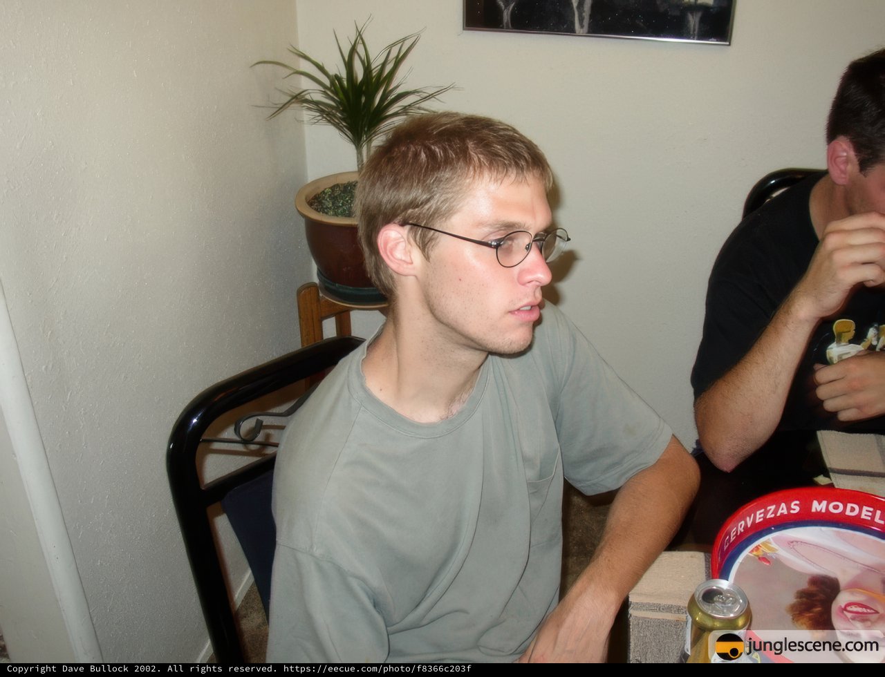 Two Men Enjoying a Potted Plant in a Decorative Container at Dining Table