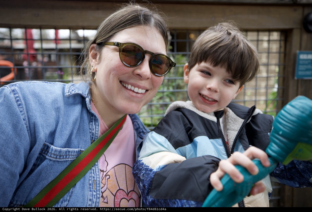 Mother and Son Smiling Together at Outdoor Venue