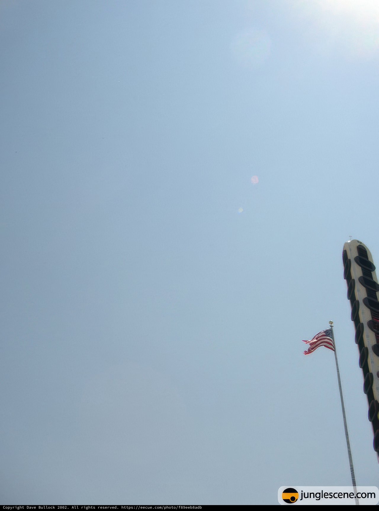 American Flag flying high alongside a kite