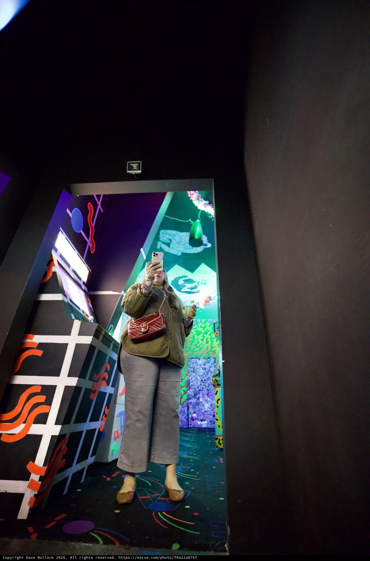 Visitor Photographing Interactive Art Installation in Museum