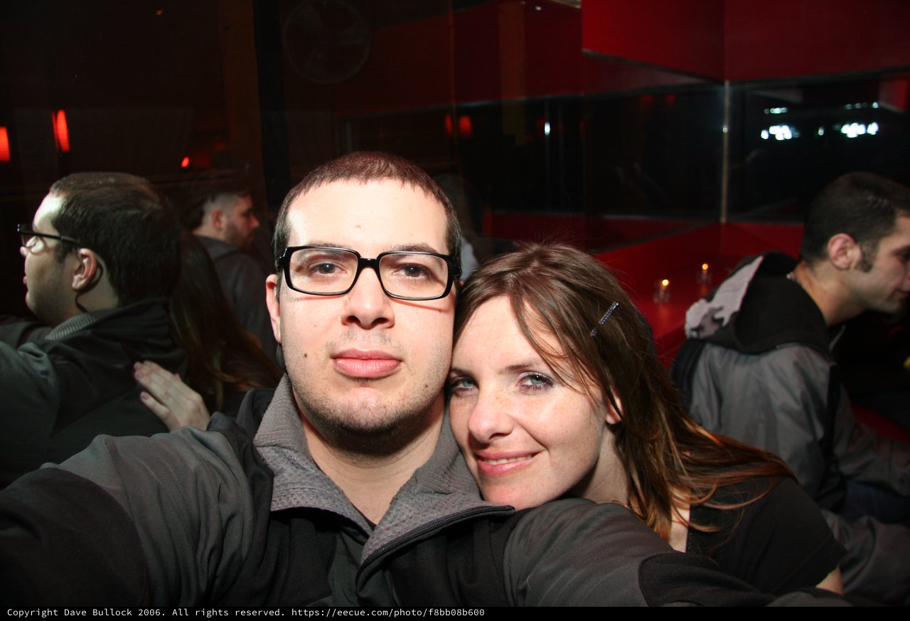 Friends Pose Together at Dimly Lit Nightclub