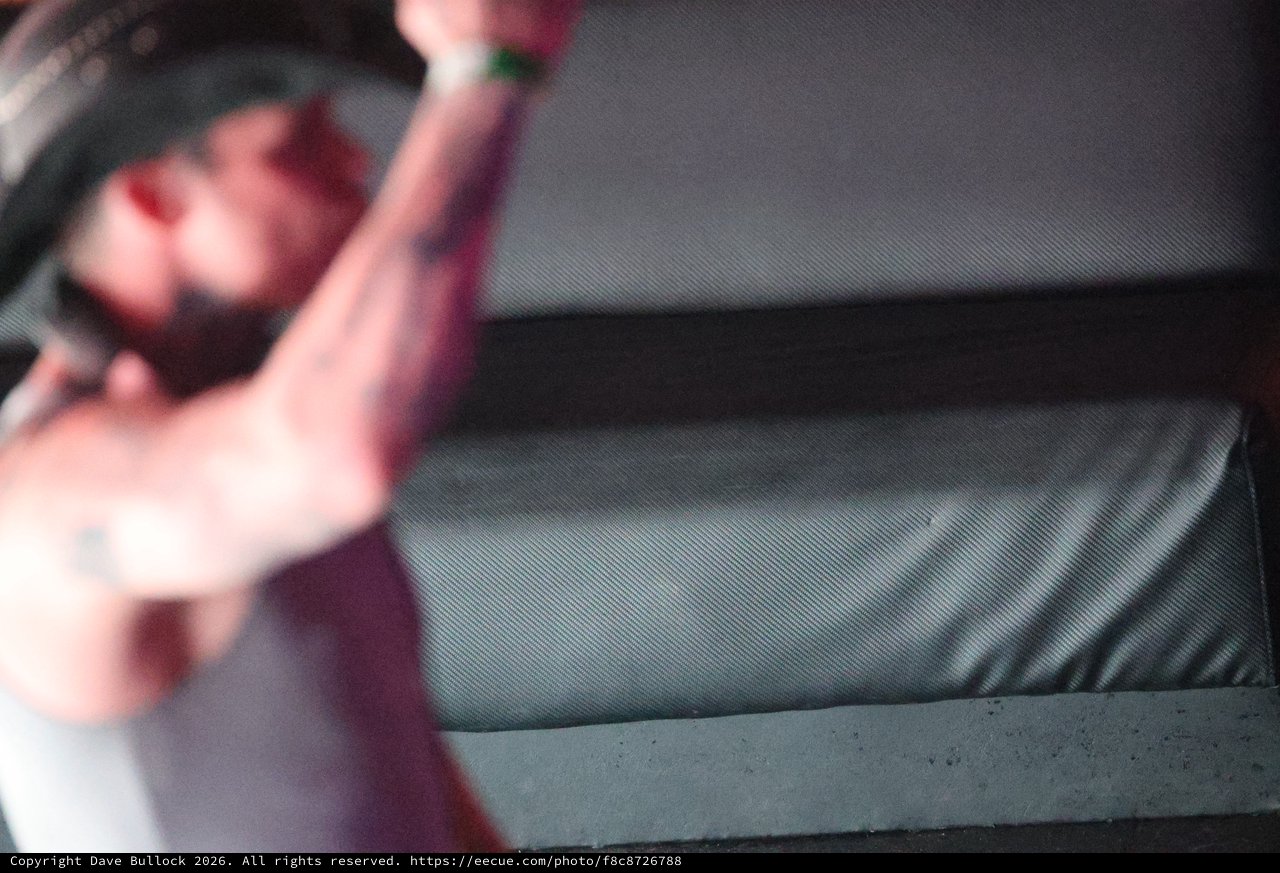 Tattooed Hand Reaches Toward Concert Stage Monitor