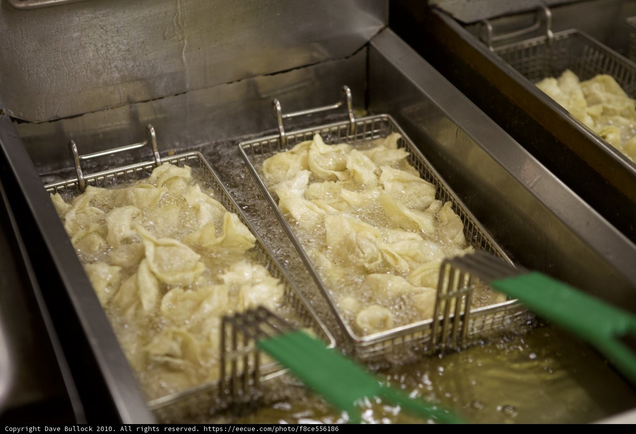 Dumplings sizzling in the fryer
