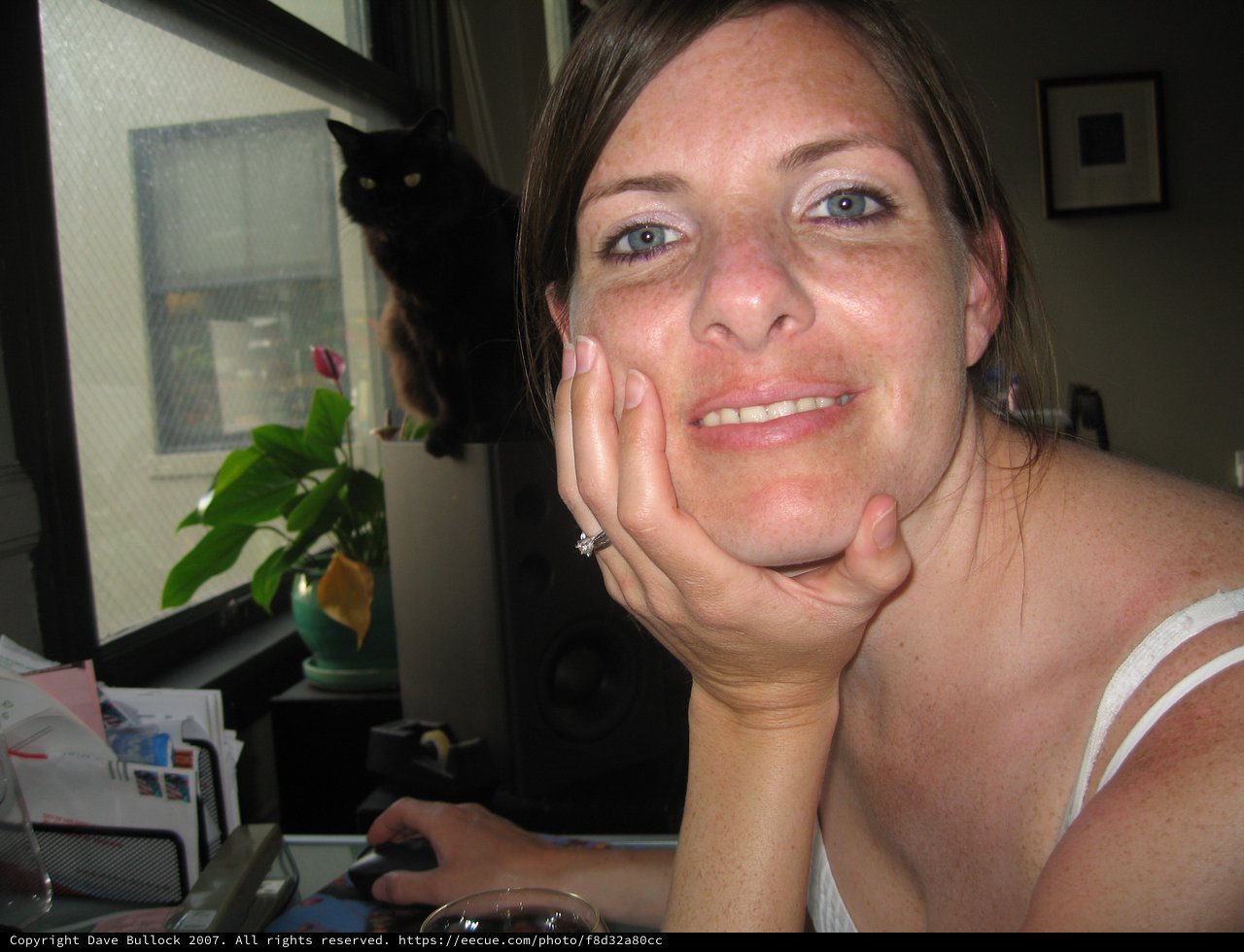 Penelope Smiling at Desk with Black Cat