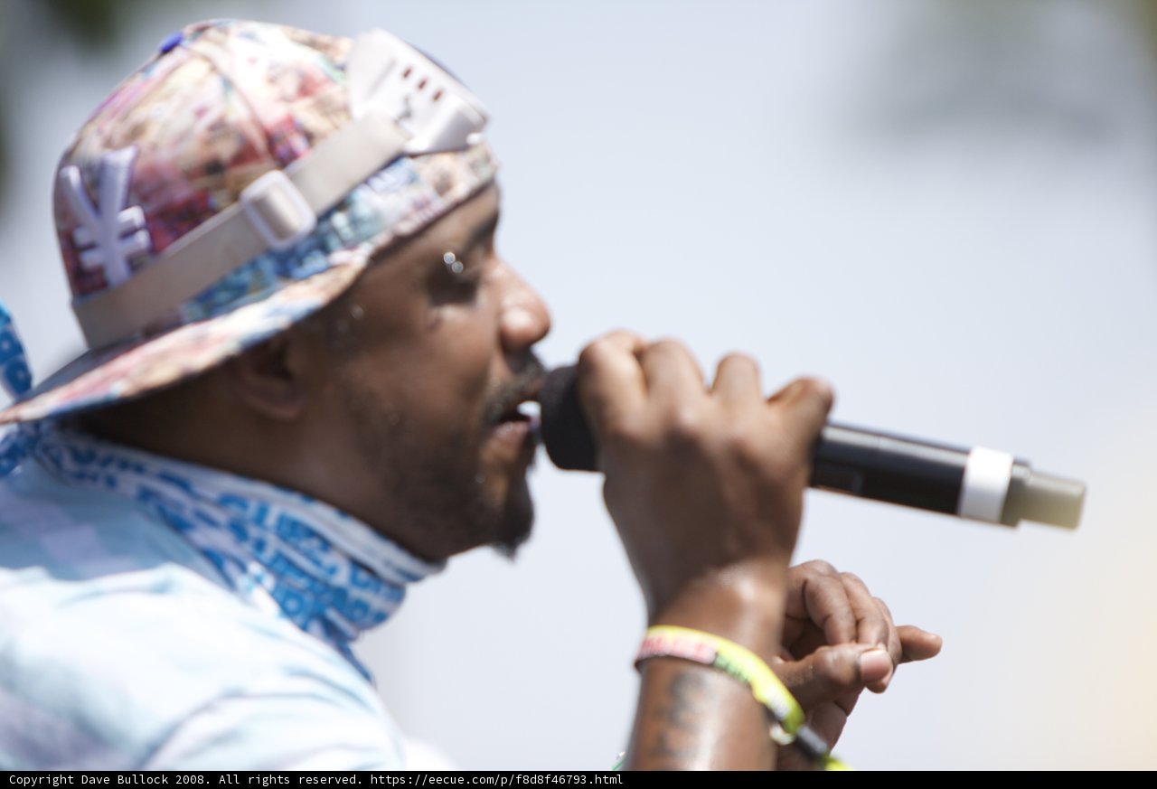 Hat-wearing Performer with Microphone
