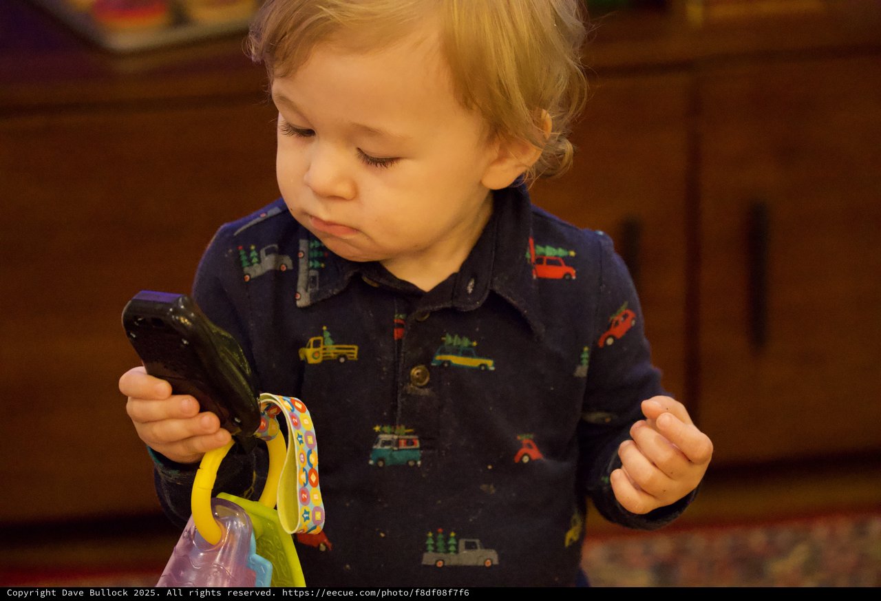Toddler Exploring Smartphone During Christmas Time