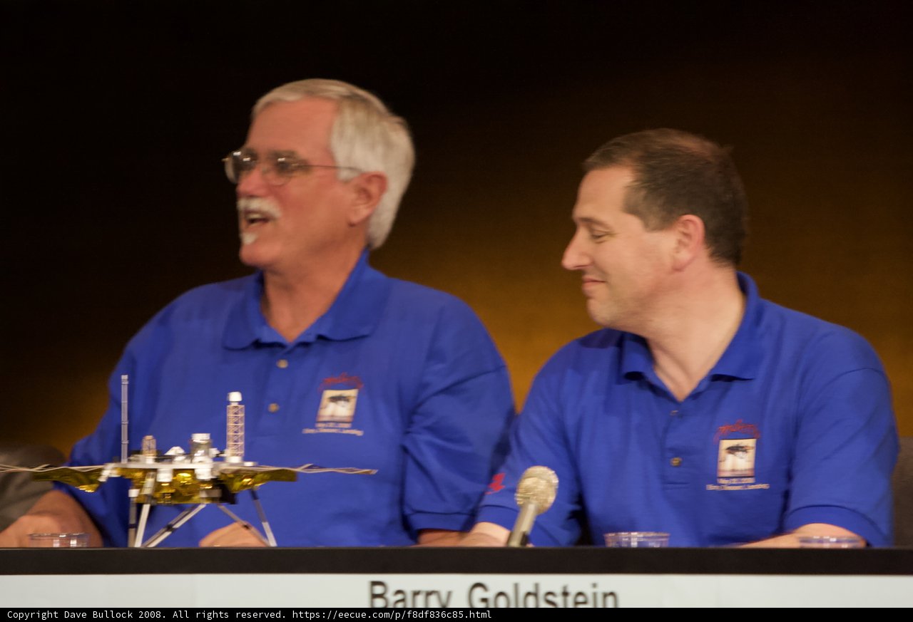 Press Conference with Two Men and Microphone