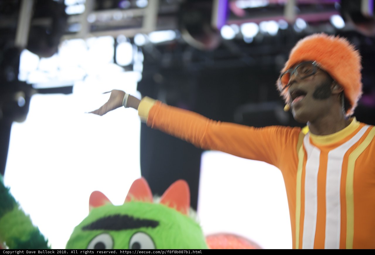 Man in Orange on Stage