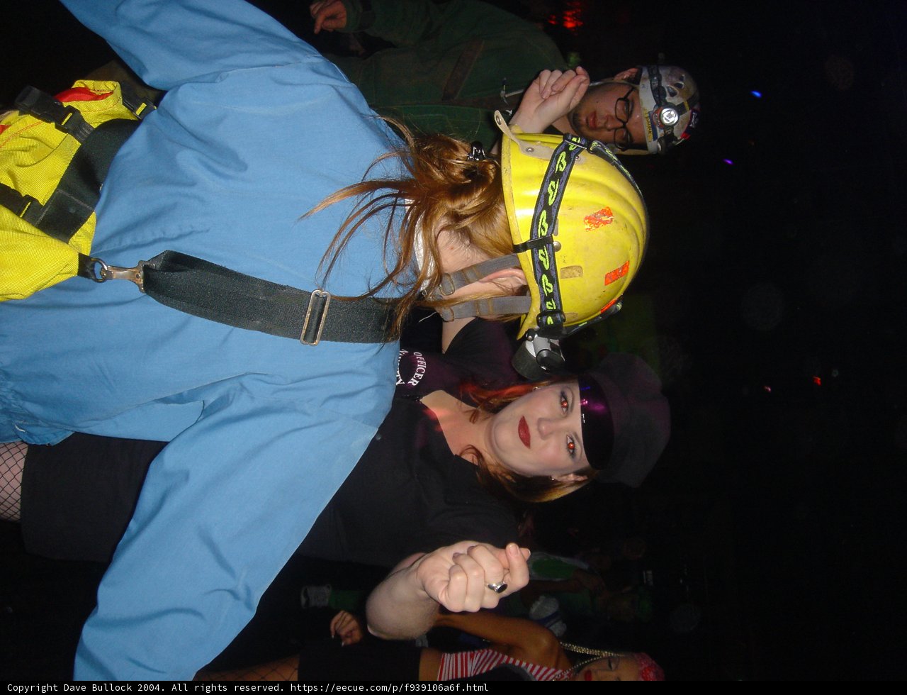 Safety First Caption: A woman wearing a helmet while playing American football with friends. Hardhat and crash helmet tags indicate the protective nature of her headgear.