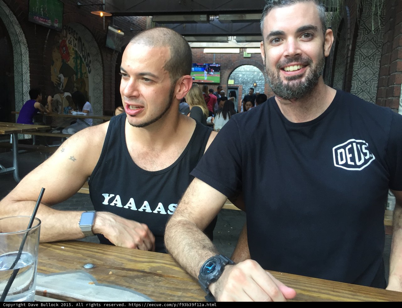 Two bearded men enjoying drinks at a Long Beach restaurant