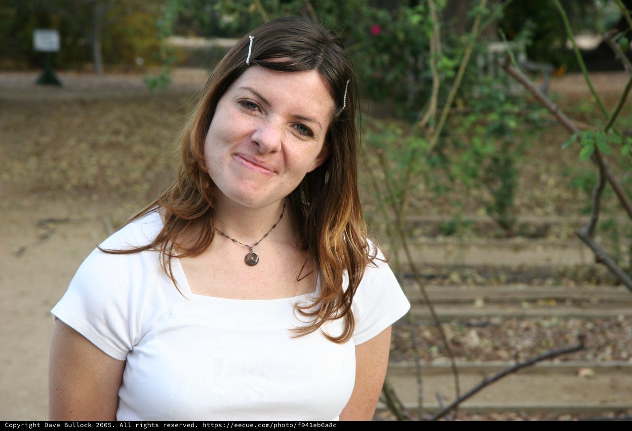 Young Woman Smiling Outdoors in Warm Afternoon Light