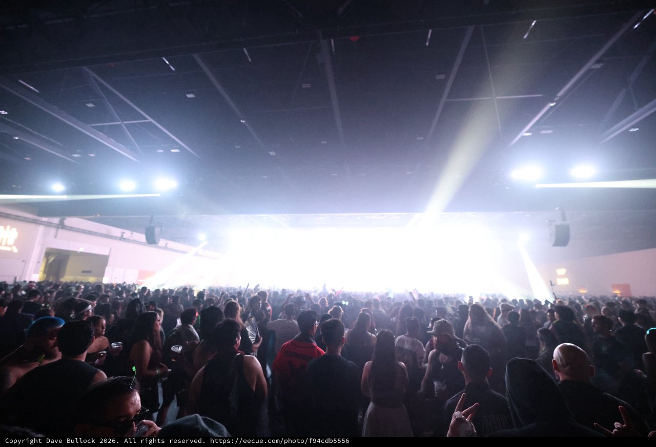 Massive Indoor Rave Crowd Bathed in Blinding Stage Light