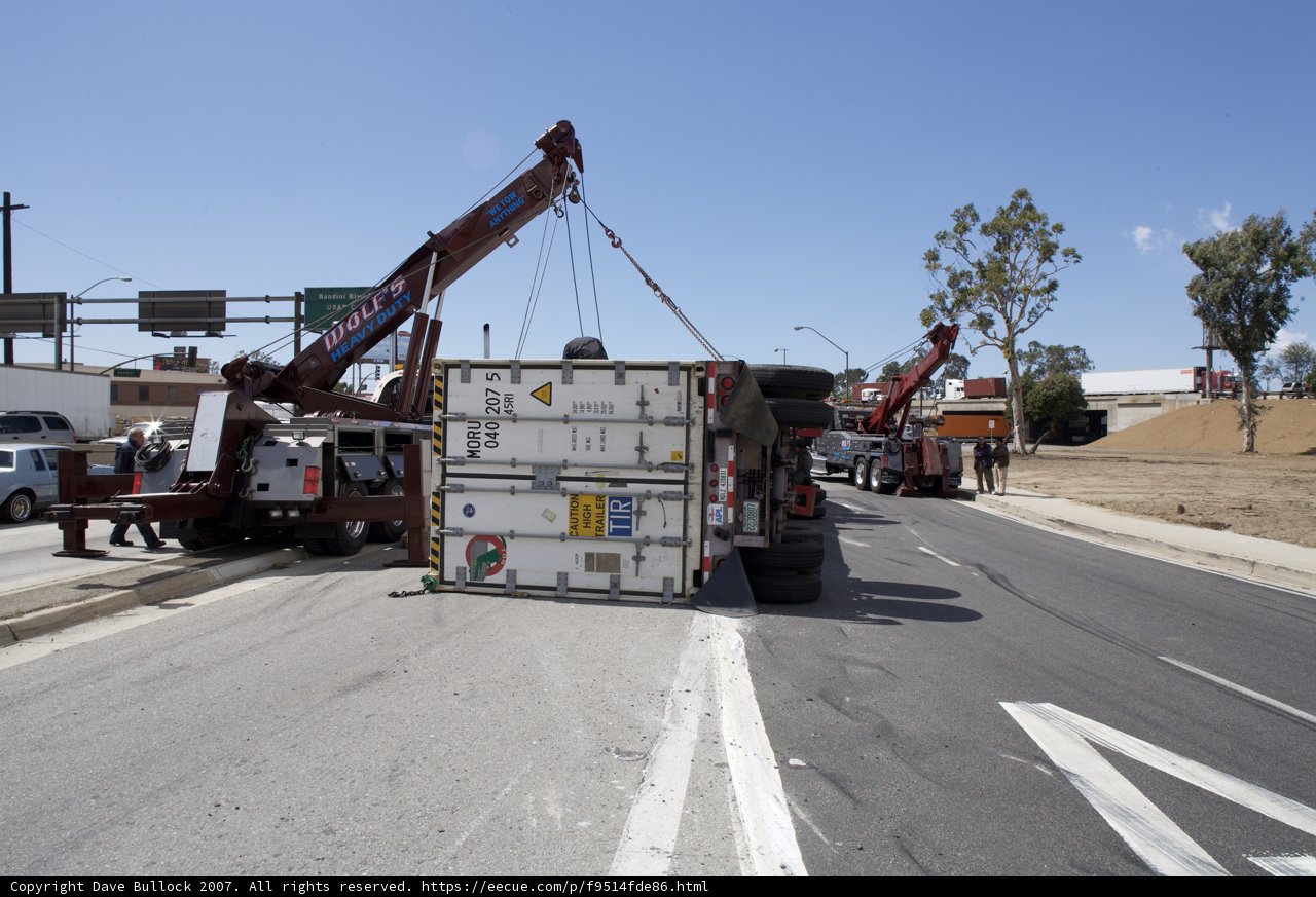 Crane Lifting Overturned Truck on the Street
