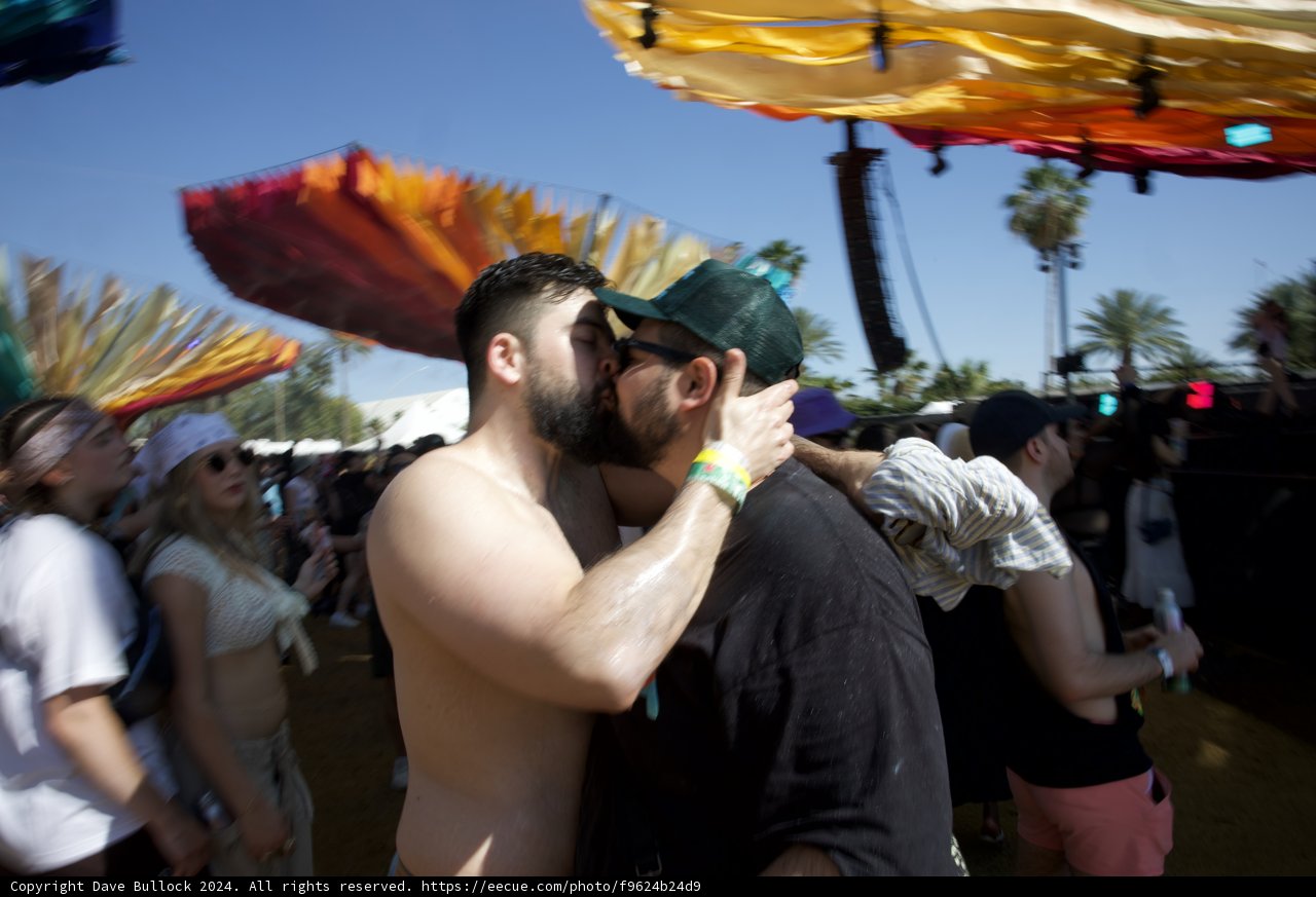 Embrace in Motion: A Romantic Interlude at Coachella 2024