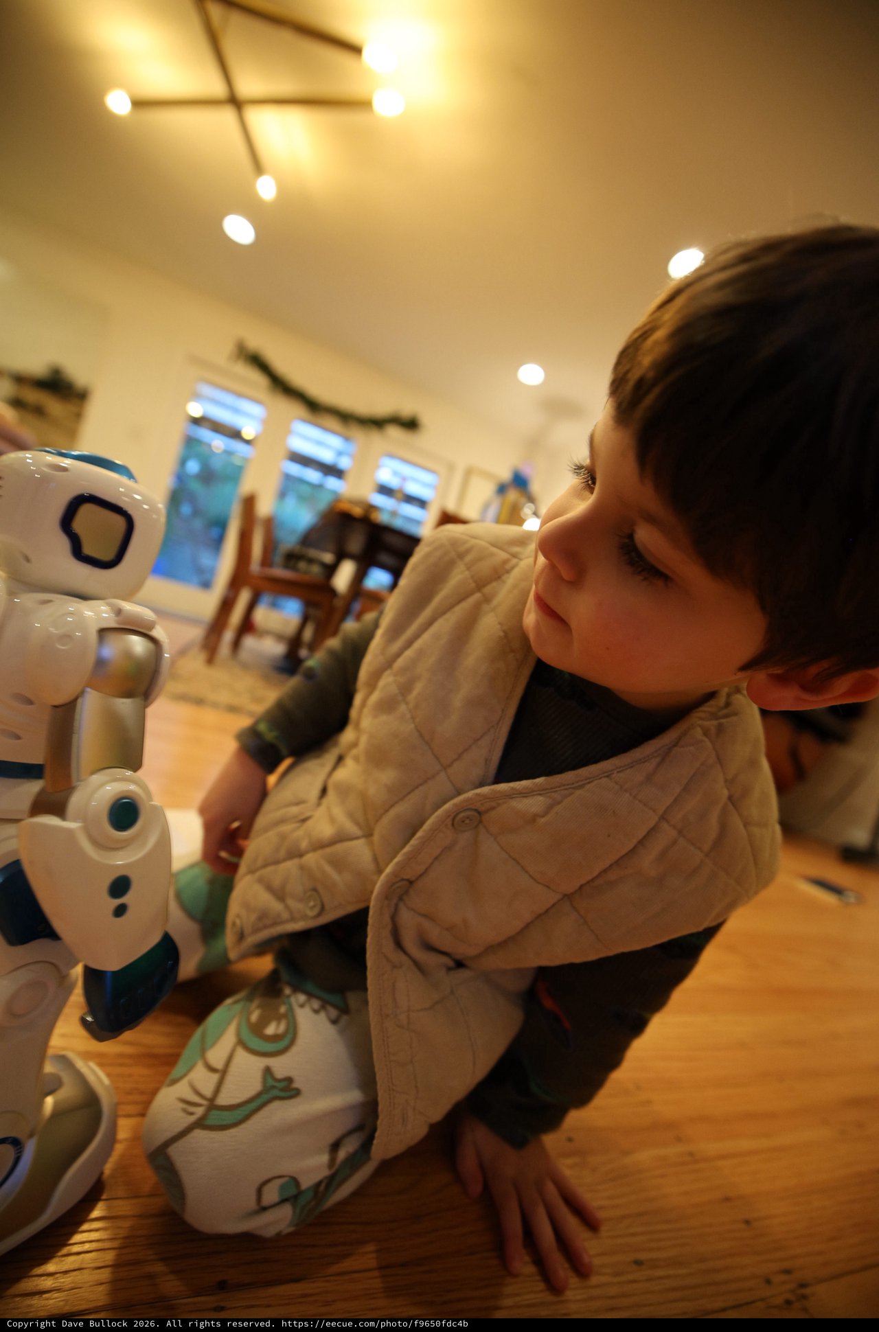 Toddler's Fascination with Interactive Robot Toy at Home