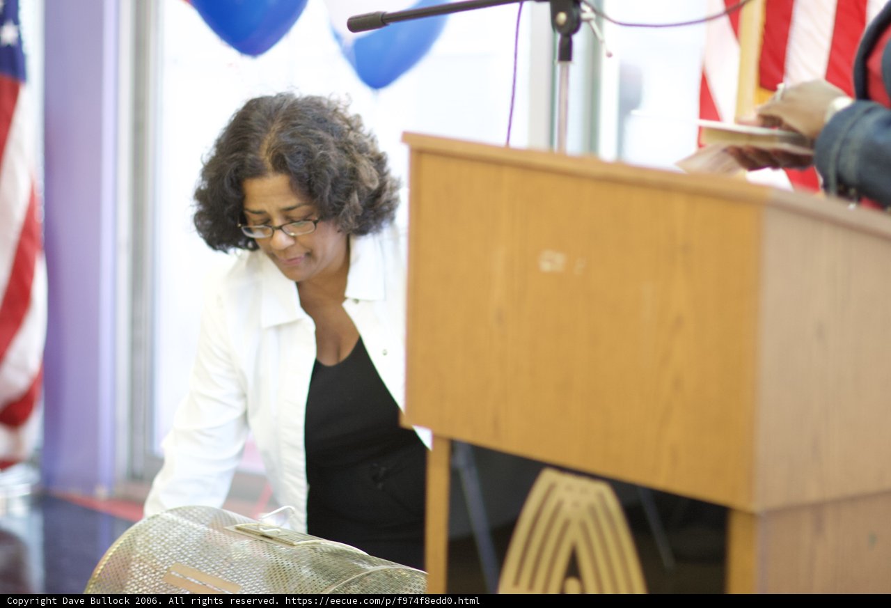 Woman on Podium with US Flag and Microphone