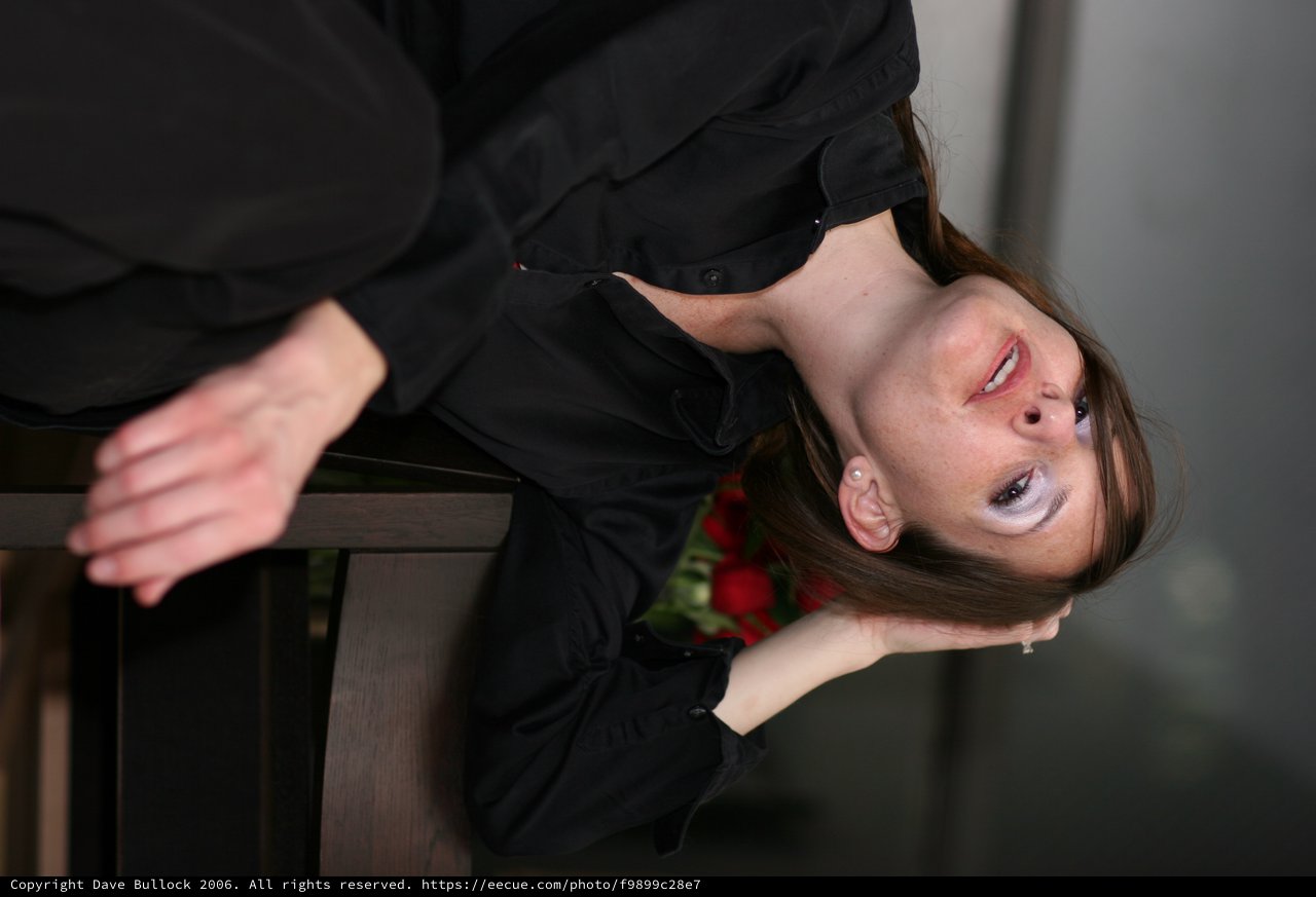 Pensive Woman in Black Gazing Upward Dramatically