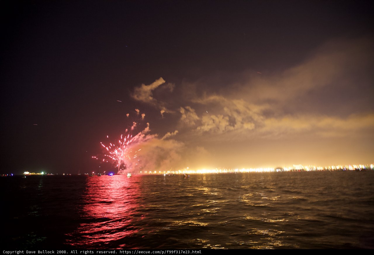 A Flare of Fireworks on the Water at Night