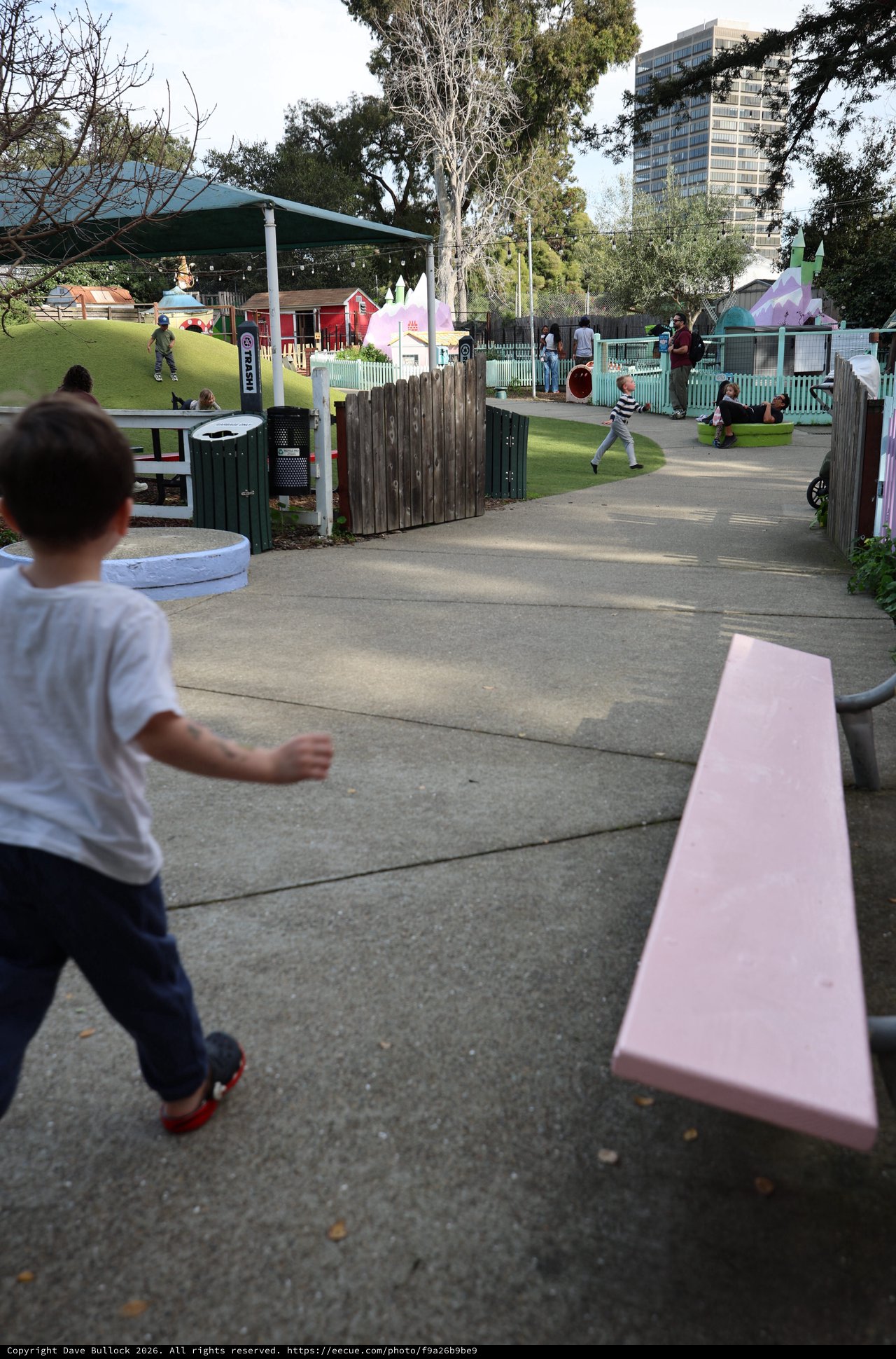 Child Running Through a Community Playground Path