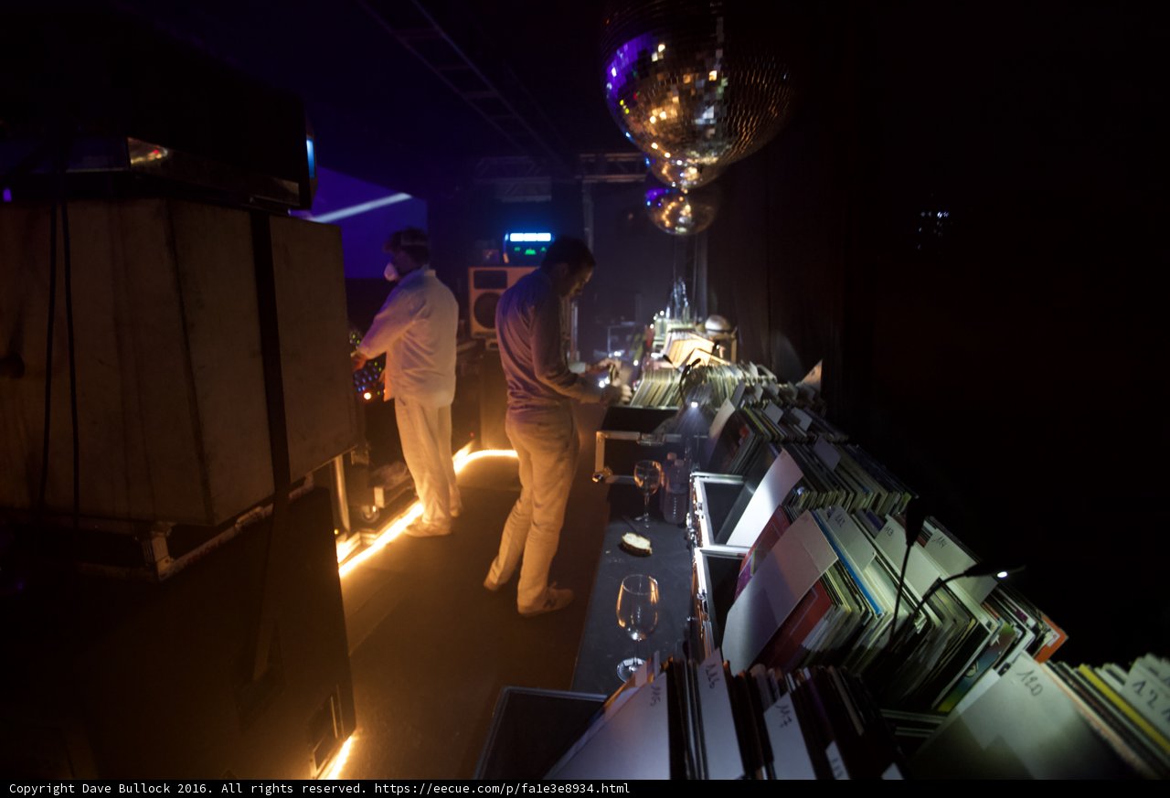 Man in White with Lamp in Spotlight